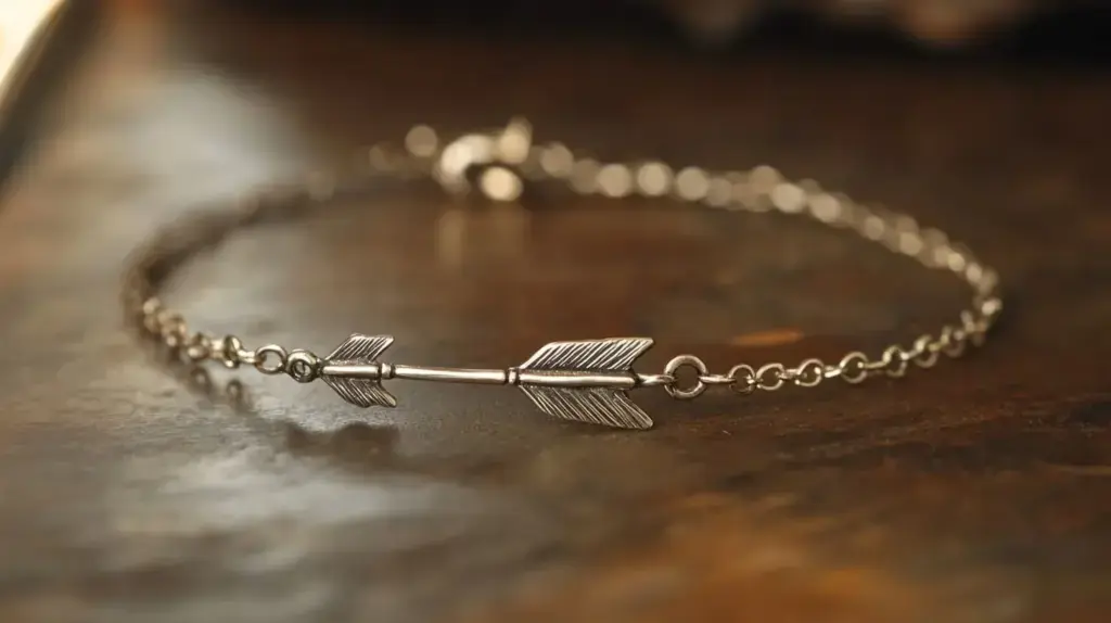 Minimalist silver arrow bracelet on a wooden surface, symbolizing progress, personal growth, and forward movement.